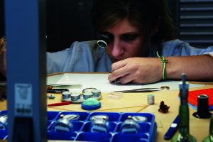 A young watchmaker assembling a complication