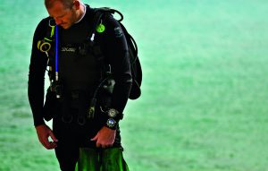 Jason Heaton with the Aquatimer Chronograph strapped to his wrist, fresh out of the water and decked in full diving gear. 